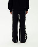 GOODBRAND Love is Good Pearl-Print Sweatpants Black porté avec un look streetwear